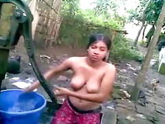 Village girl bathing outdoor and took a self